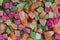 Background candied colorful fruit. Dried pineapple bits. Colored dried tropical fruit. Close up