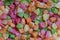 Background candied colorful fruit. Dried pineapple bits. Colored dried tropical fruit. Close up