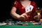 BACKGROUND FOR CASINO. A girl in an evening red dress plays in a casino, holds aces cards. Gambling business casino