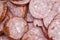 A background of chopped pieces of sausage. High -quality smoked red sausage salami with a lot of fat and spices background