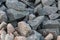 A background of cobblestone stones close-up. stones for the construction of the foundation. Crisis construction of expensive