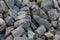 A background of cobblestone stones close-up. stones for the construction of the foundation. Crisis construction of expensive