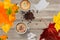 Background of coffee, cappuccino, sugar, milk, cookies on the table. Autumn, fall leaves.