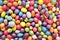 Background of colored oval and round candies, colored stones