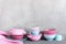 Background with colorful crockery, on the grey table against tex