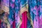 Background of colorful draped overlapping fabrics in pinks and turquoise with gold yellow embroidered design -boho or gypsy look