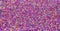 Background of colorful purple sprinkles. Food texture and pattern.