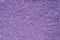 Background of colorful purple sprinkles. Food texture and pattern.