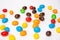 Background of colorful rainbow round candies, flat lay, top view. Treats for children. Sweet dessert for kids