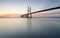 Background with colourful sunrise on the Lisbon bridge. The Vasco da Gama Bridge is a landmark, and one of the longest bridges in