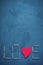 Background of concrete and blue paint plaster. On the texture matches arranged in the form of the word Love. In the middle o