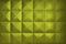 Background consists of large yellow squares. Unusual, beautiful and modern background. Rhombic gold color wall of big squares