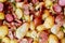 Background of cooked potato, smoked meat and sausage mix.