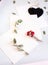 Background with copy space blank on table with black heart, eucalyptus branch, roses flowers and leafs. White paper top view, flat