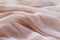 Background of coral fabric lying folds on the table