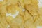 Background corrugated golden chips with texture .