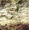 Background with cracked brown, gray and beige rock structure