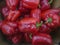 Background cut red sweet pepper in basket bulgarian pepper fresh, assorted colorful capsicum paprika on a counter in the