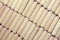 Background of cylindrical wooden dowels, diagonal view