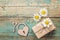 Background with daisies, gift box, lock-heart and key on old boa