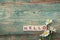 Background with daisies and nd inscription hello on old boards w