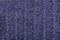 Background from dark blue and white woolen pile thread.Knitted structure pattern.Top view.Soft focus.Textured surface concept for