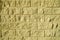 Background from a decorative imitation of a bricklaying of light yellow color