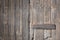 Background and detail of an old weathered closed wooden door that is in landscape format in an old wall
