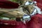 Background, detail of a silver-colored balloon resting on a red mantle. abstract background.