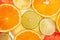 Background of different colored slices of citrus fruits close up