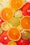 Background of different colored slices of citrus fruits close up