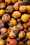 A background of discarded rotten fruits left to waste after the market. Apricots