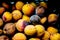 A background of discarded rotten fruits left to waste after the market. Apricots