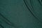 Background of draped dark green fabric with silver lurex thread