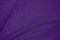 Background of draped dark purple fabric with silver lurex thread