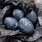 Background with easter eggs. Naturally dyed eggs prepared for Easter on on black crumpled paper. Happy Easter