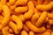 Background of extruded cheese puffs. Top view