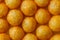 Background of extruded puff cheese balls from above.