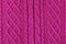 Background from a fabric texture. Wool knitted fabric with cable seamless pattern of pink-red color. Textile closeup