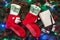 Background of fir branches. Santa`s red stockings with money. Christmas card. Top view. Xmas congratulations. Message book