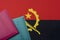 On the background of the Flag of Angola lie the passport