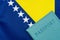 On the background of the flag of Bosnia and Herzegovina is a passport