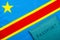 On the background of the flag of the Democratic Republic of the Congo is a passport