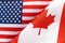 Background of the flags of the USA and canada. The concept of interaction or counteraction between two countries. International