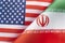 Background of the flags of the USA and iran. The concept of interaction or counteraction between two countries. International