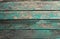 Background in the form of four horizontal wooden boards of green color with peeling paint