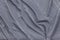 Background in the form of a gray fabric material with diagonal white broken lines