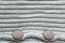 Background in the form of a knitted wool product with a horizontal pattern and two buttons at the bottom of the image