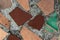 Background in the form of pieces of an old multi-colored floor tile in hardened concrete