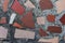 Background in the form of pieces of an old multi-colored tile in the hardened concrete